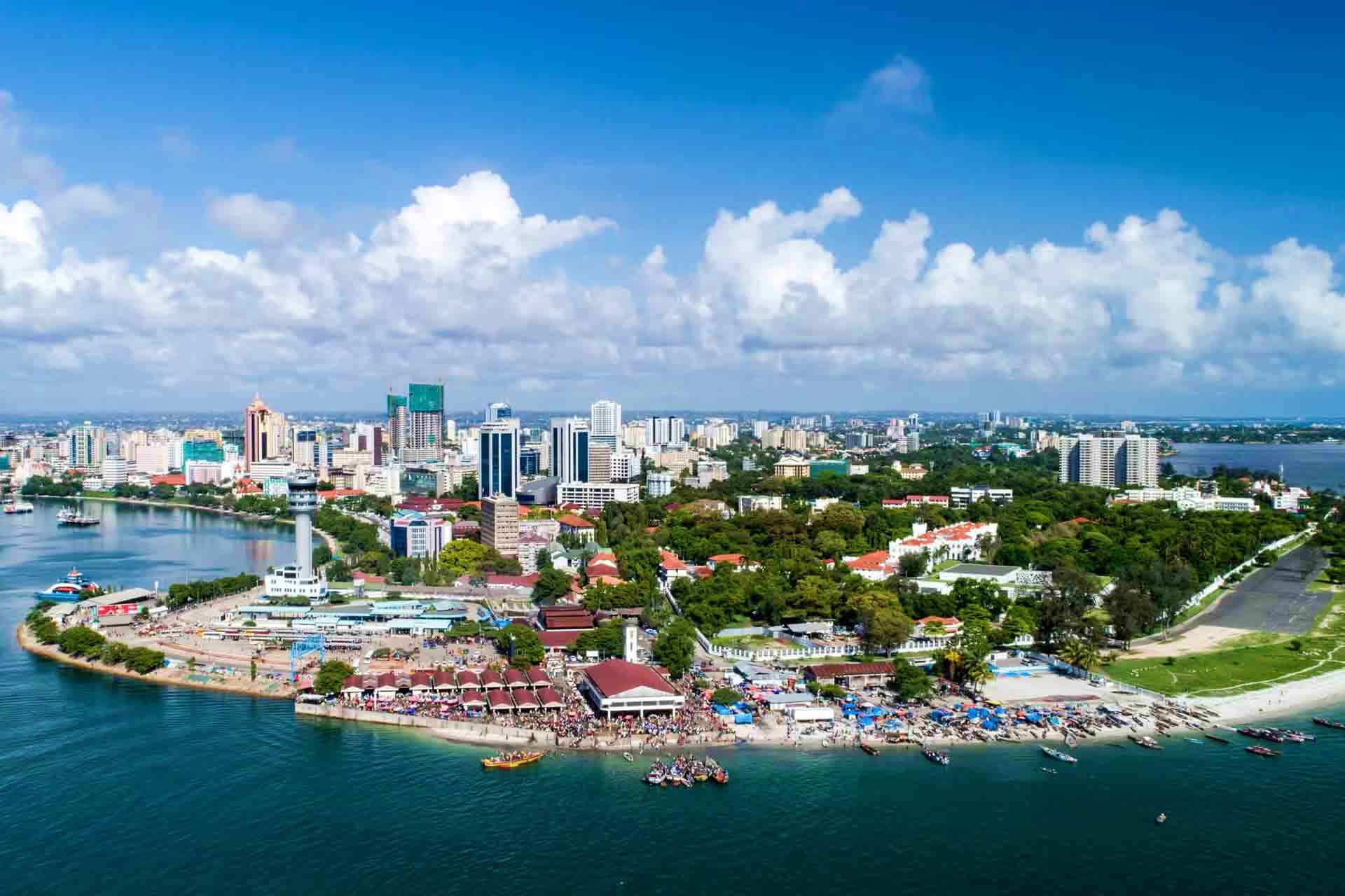 Aerial view of Dar es Salaam city skyline with waterfront, beaches, and harbor in Tanzania